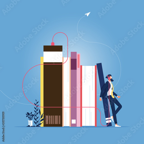 Listening or reading online Concept-Online education, Businessman standing near pile of books with headphones and listen them online