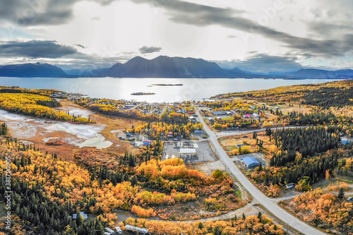 The small northern British Columbian town of Atlin near the Yukon Territory border. Taken by drone aerial shot in September during the peak fall autumn colors with yellow bright trees. 
