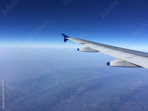 view Outside an airplane window with the airplane wing.