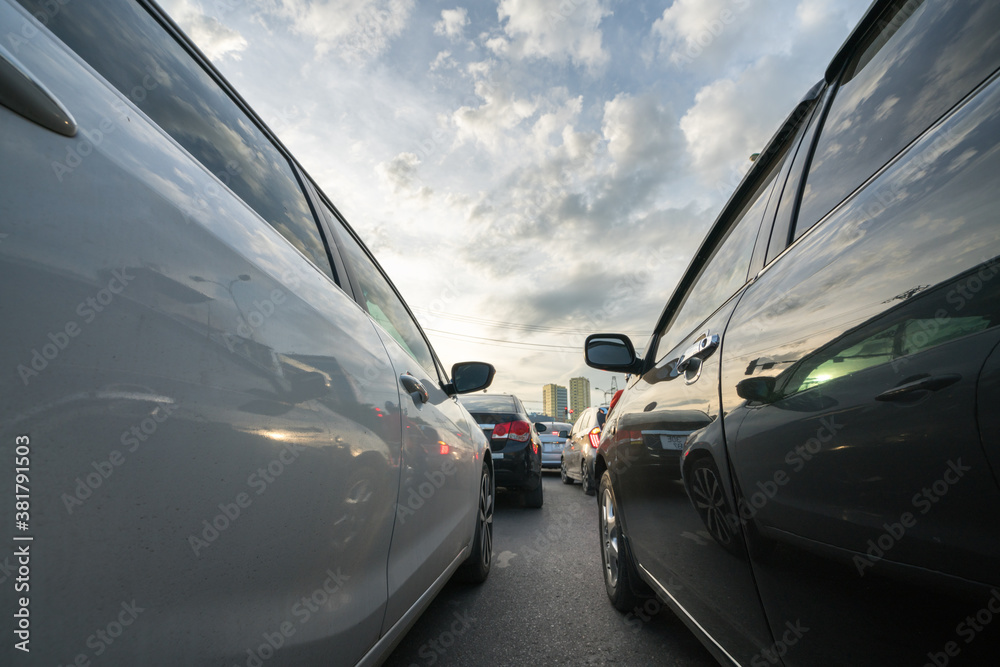 Cars on city street in traffic jam at rush hour