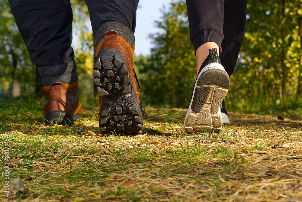 Man hiking in the woods in Autumn pine forest. Men boots walking in the woods on sunny day. hiking concept, outdoor lifestyle. Man hiking in the woods in Autumn pine forest. Men boots walking in the woods on sunny day. hiking concept, outdoor lifestyle.