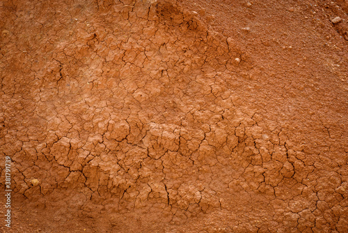 Top view cracked red soil. Picture of natural disaster. Drought land, global warming and deforestation. Image of brown soil texture, close up. Desert realistic background.