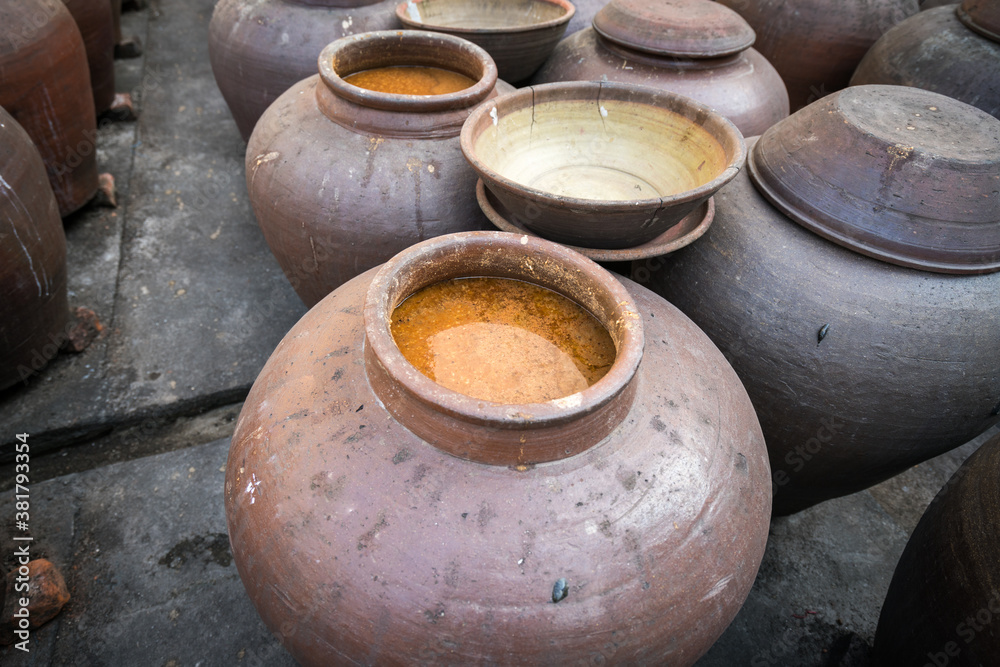 Jars of processing soybean jam made by traditional outdoor way under natural sunlight Jars of processing soybean jam made by traditional outdoor way under natural sunlight