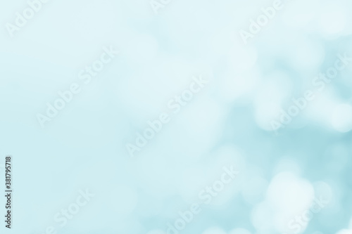 Natural spring blurred blue sea background. Create light soft blurred colors bright sunshine. Blue bokeh abstract glitter light background. Focus texture from nature fresh shiny growth seas the day.