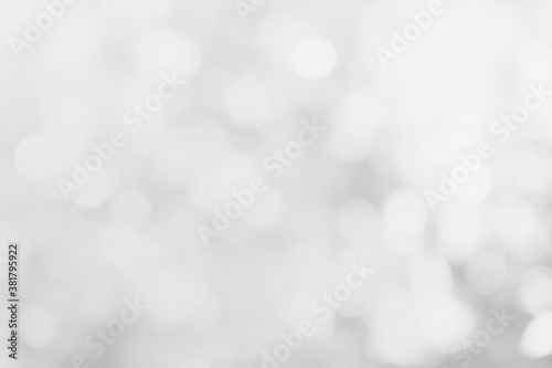 Gray and white nature blurred color glow colorful light sparkling summer. Abstract bokeh white texture with soft foreground bubble shiny in grey vintage style shine. Blur wall.