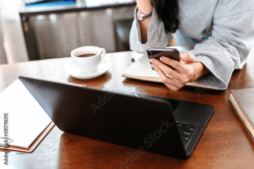 woman using mobile phone while working at home. Businesswoman working concept.