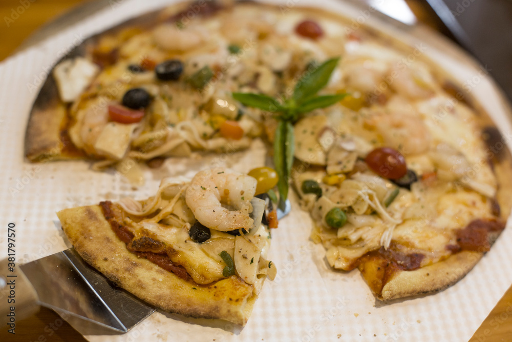 Delicious cheese stringy slice lifted of full supreme pizza baked fresh out of the oven. Delicious cheese stringy slice lifted of full supreme pizza baked fresh out of the oven.