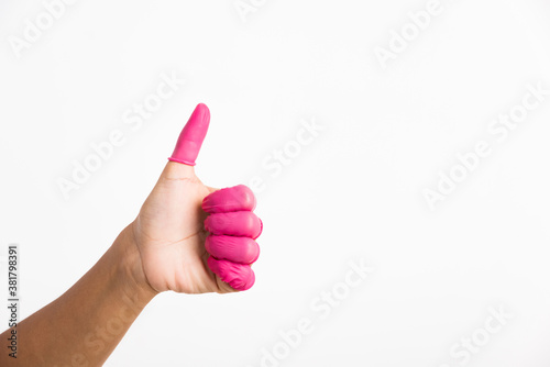 Woman hand wearing pink finger cots rubber protect photo