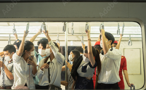 Many people on the train wear anti-virus masks and travel during rush hours.