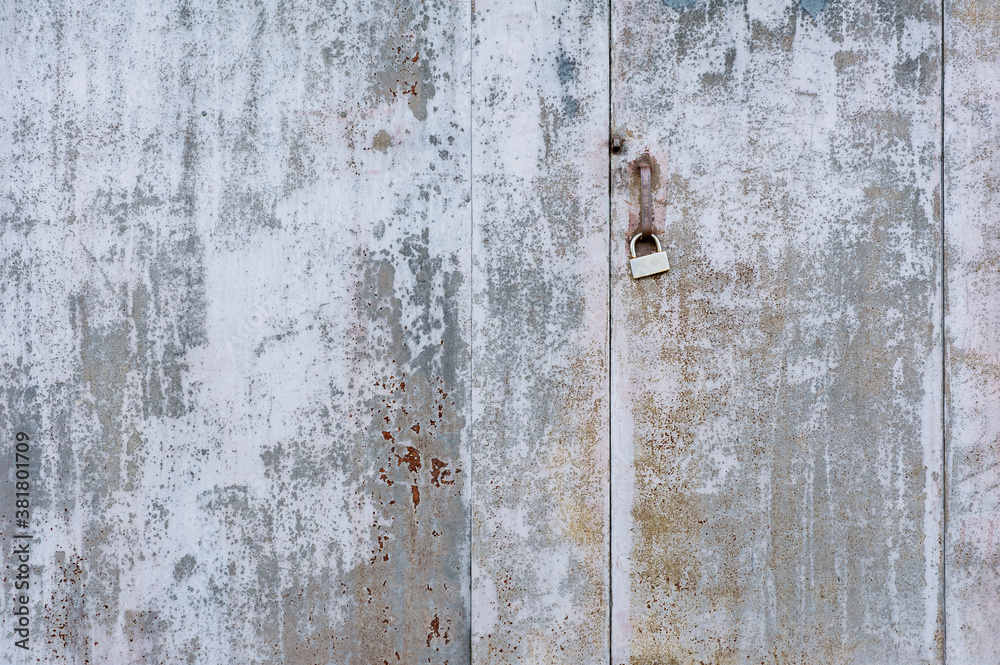 Texture, old metal gray wall and door, with paint-coated lock. Texture, old metal gray wall and door, with paint-coated lock.
