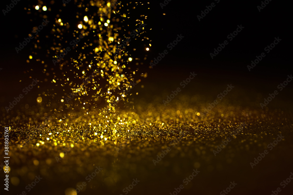 Sparkling golden glittering effect isolated on black background. Sparkling golden glittering effect isolated on black background.