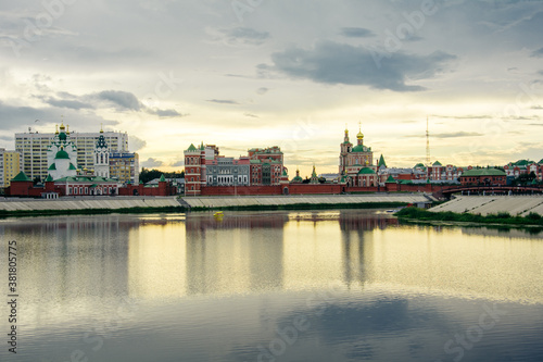 Russia, Yoshkar-Ola, July 24, 2020, sunset, view from the embankment of the Kokshaga river to the Kremlin, reflection in the water.