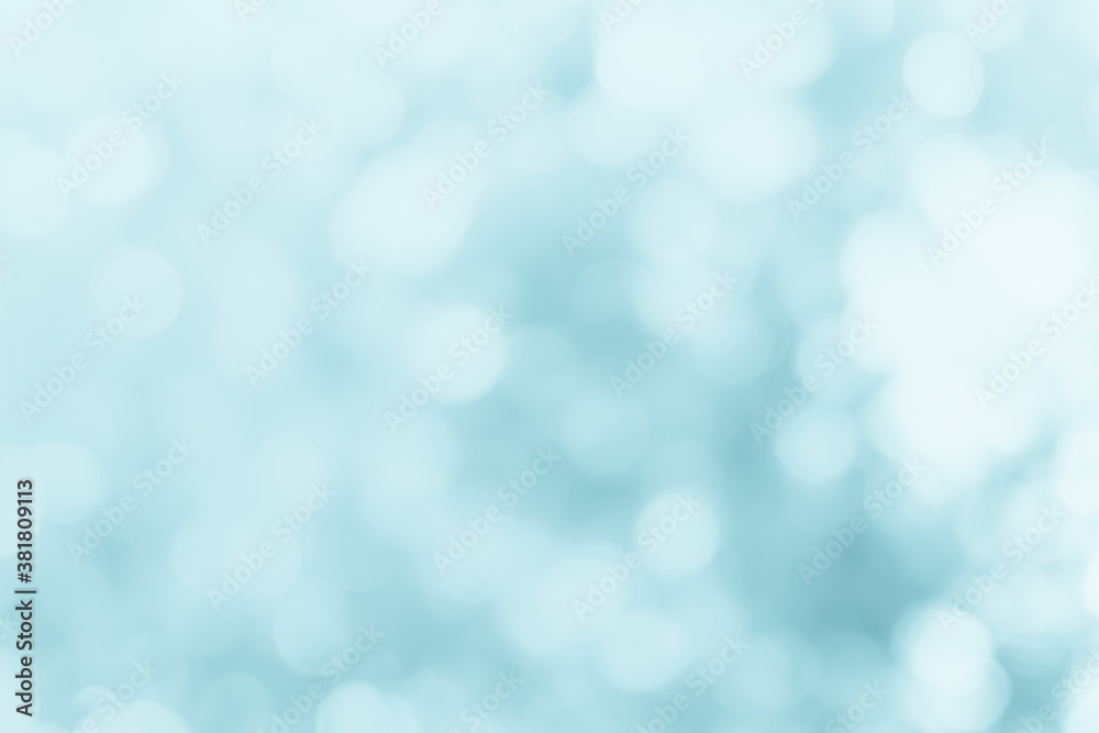 Natural spring blurred blue sea background. Create light soft blurred colors bright sunshine. Blue bokeh abstract glitter light background. Focus texture from nature fresh shiny growth seas the day.