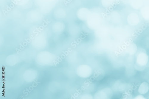 Natural spring blurred blue sea background. Create light soft blurred colors bright sunshine. Blue bokeh abstract glitter light background. Focus texture from nature fresh shiny growth seas the day.