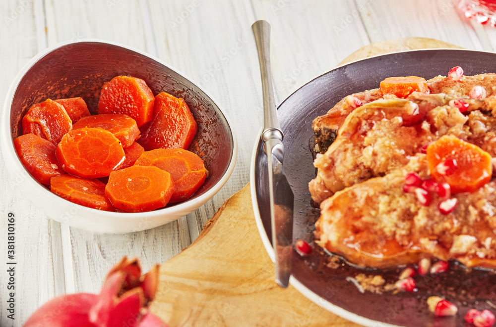 Carrot slices with Gefilte fish with horseradish and pomegranate, an authentic Jewish dish Carrot slices with Gefilte fish with horseradish and pomegranate, an authentic Jewish dish