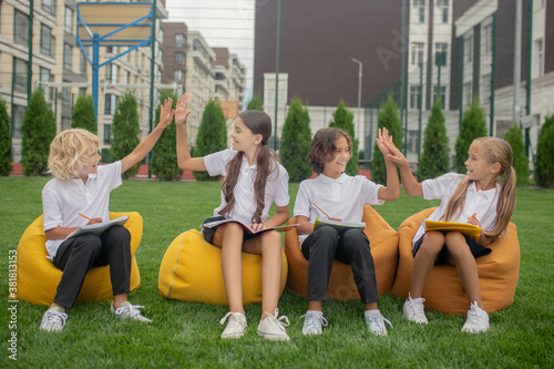 Children sitting on bag chairs and feeling cheerful