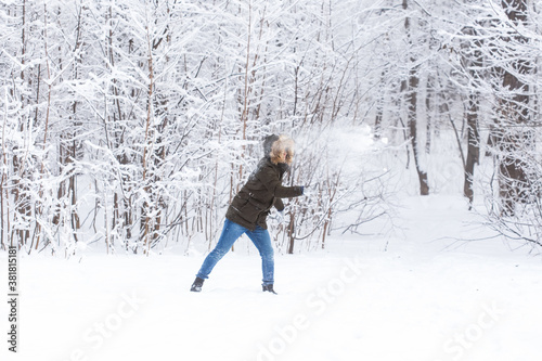 Lifestyle, season and leisure concept - Funny couple playing snowball in winter park © satura_