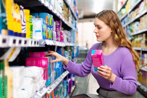 Portrait of pleasant beautiful positive woman customer buying personal hygiene items in the supermarket