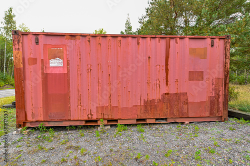 iso container painted red standing on gravel