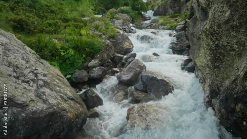 Strong flow of narrow mountain river going down in ravine Makhar. Dangerous place Strong flow of narrow mountain river going down in ravine Makhar. Dangerous place