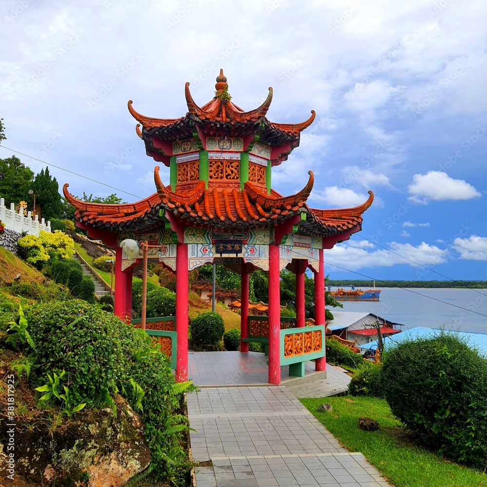 Fototapeta premium pavilion in the garden overlooking fishing village by sea side