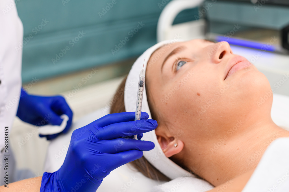 Beautician hold syringe for young female client Beautician hold syringe for young female client