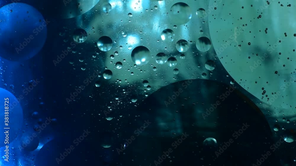 Oily transparent bubbles swing in the liquid.