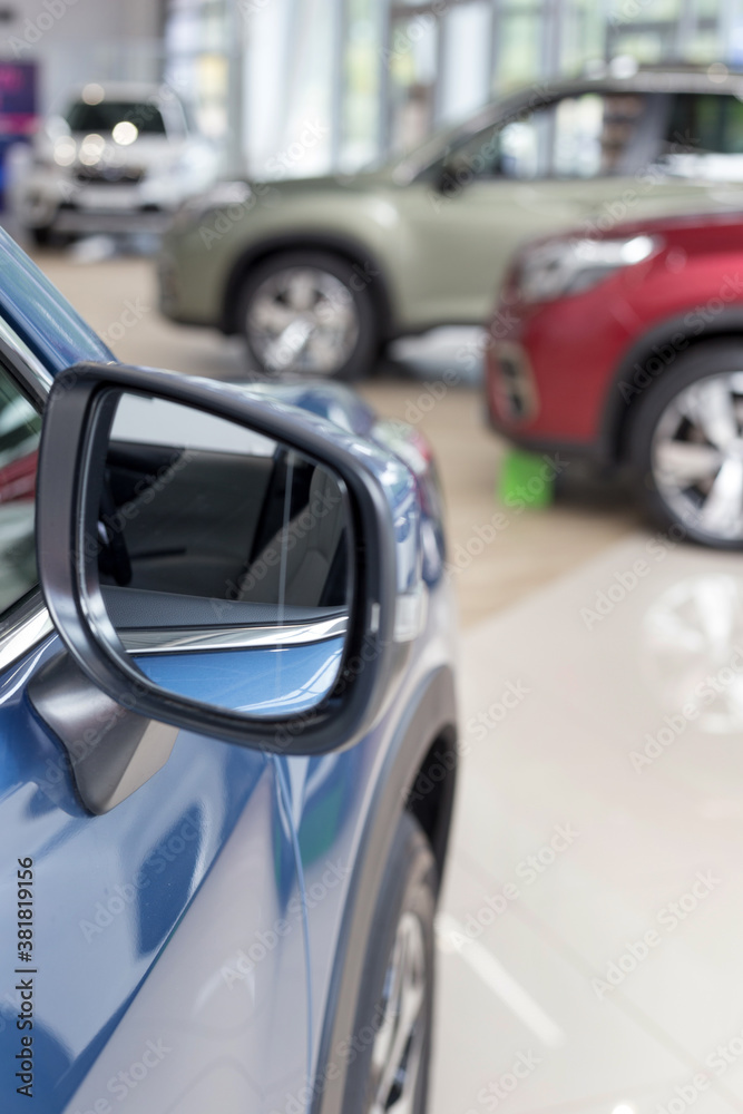 New modern cars at dealer showroom. Themed blur background with bokeh effect. Car auto dealership.