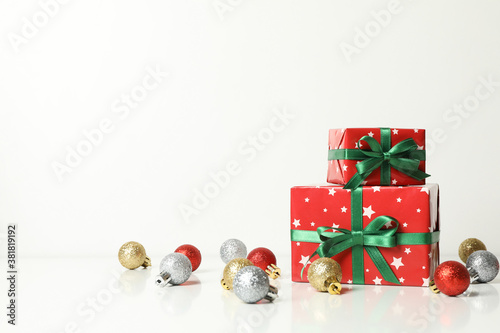 Christmas boxes and baubles on white background