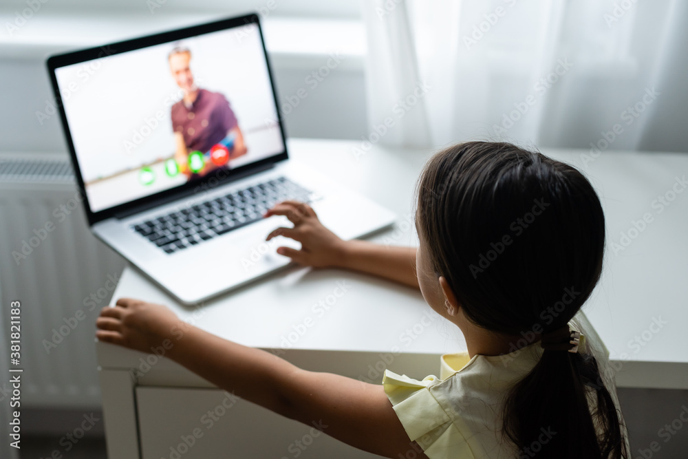 Litttle girl looking at laptop screen with expression of surprised and excitement. Smart, smilling little girl taking notes . Communication in business concept. Litttle girl looking at laptop screen with expression of surprised and excitement. Smart, smilling little girl taking notes . Communication in business concept.