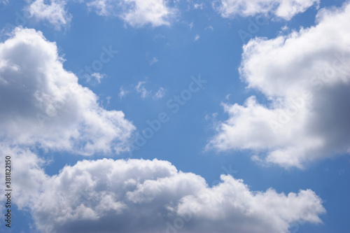 Light blue sky background with clouds.