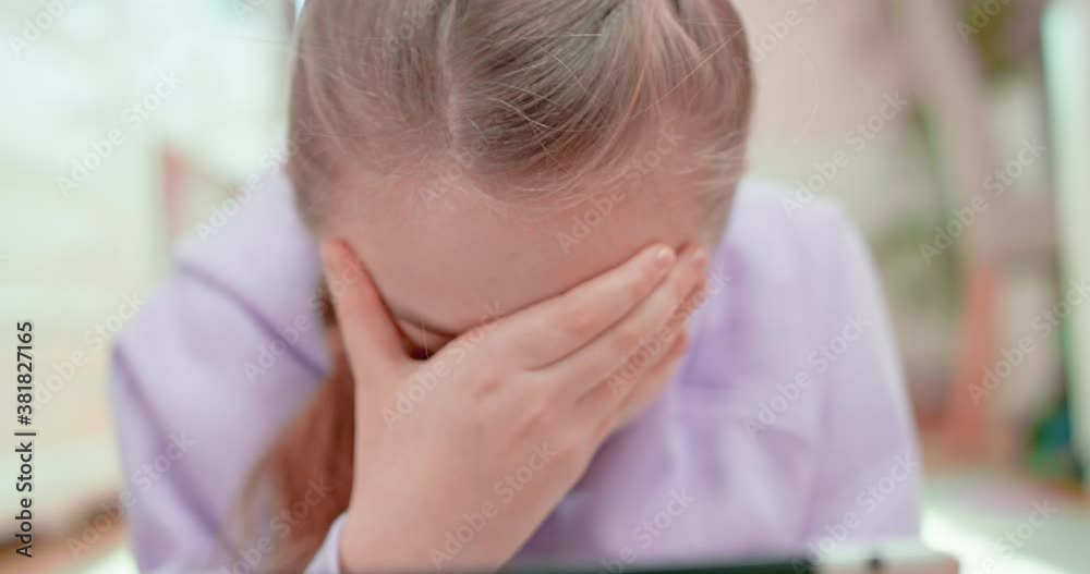 Teen girl facepalm lying on the floor in front of the tablet Teen girl facepalm lying on the floor in front of the tablet