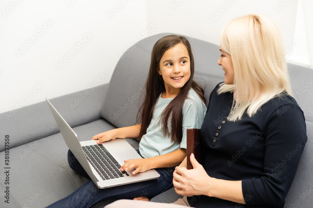 mother and daughter doing homework with a tablet mother and daughter doing homework with a tablet