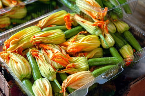 zucchini flowers and ovaries in a box for sale. Harvest delicious zucchini ovaries for cooking in batter