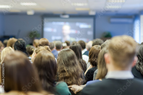 Large Group of Listeners During A Conference Looking At Screen In Front.