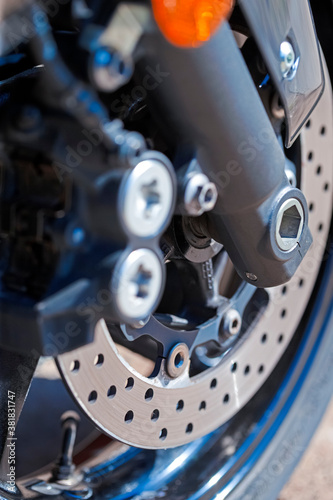 Closeup of Modern Motorcycle Front Braking System With Pads and Disks. photo