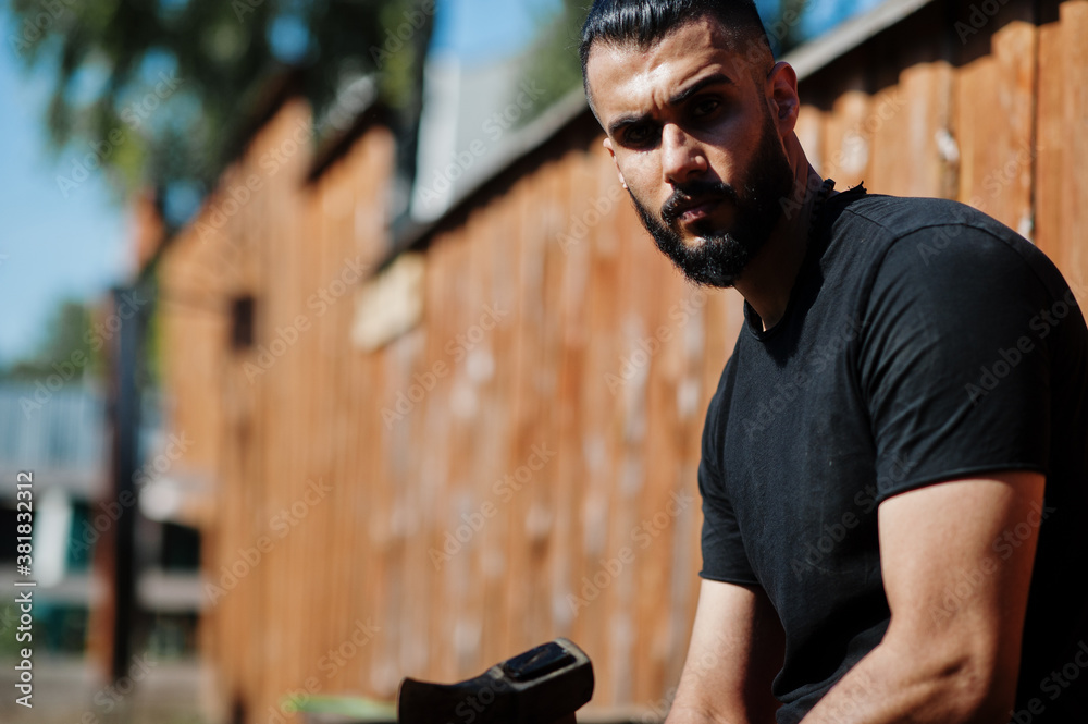 Arab hipster beard man lumberjack hold axe.