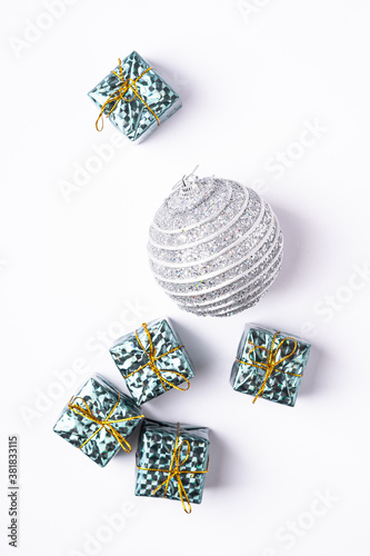 Christmas New Year composition. Gifts, silver ball decorations on white background. Winter holidays concept. Flat lay, top view