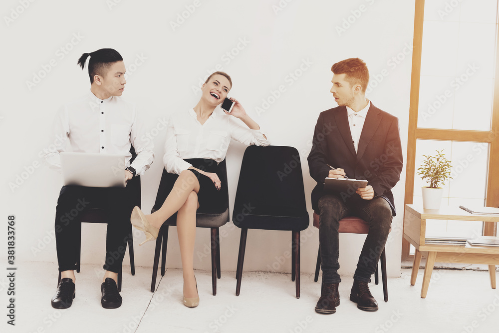 Fototapeta premium Woman laughs and speaks on phone while sitting.