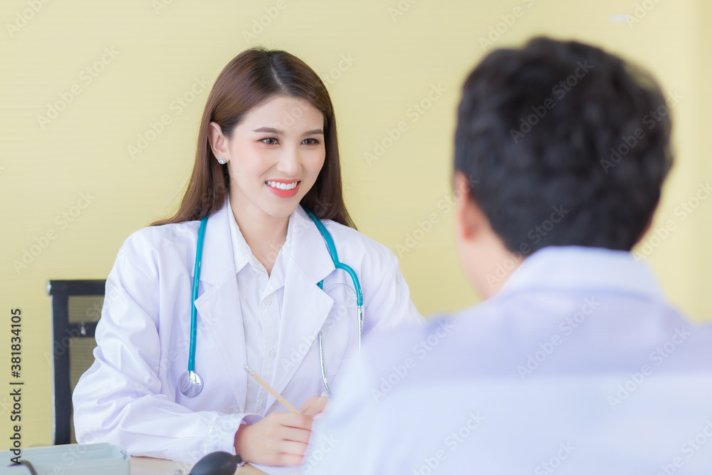 A beautiful Asian female doctor smiled and asked about the symptoms. A beautiful Asian female doctor smiled and asked about the symptoms.