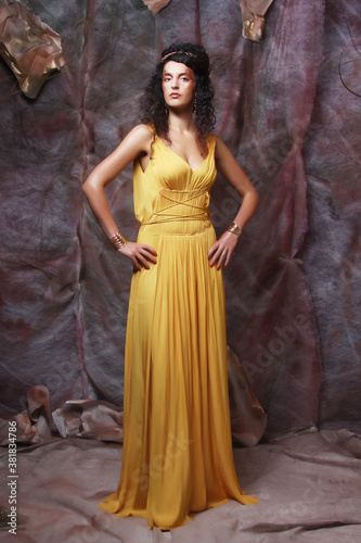 brunette woman wearing yellow evening dress