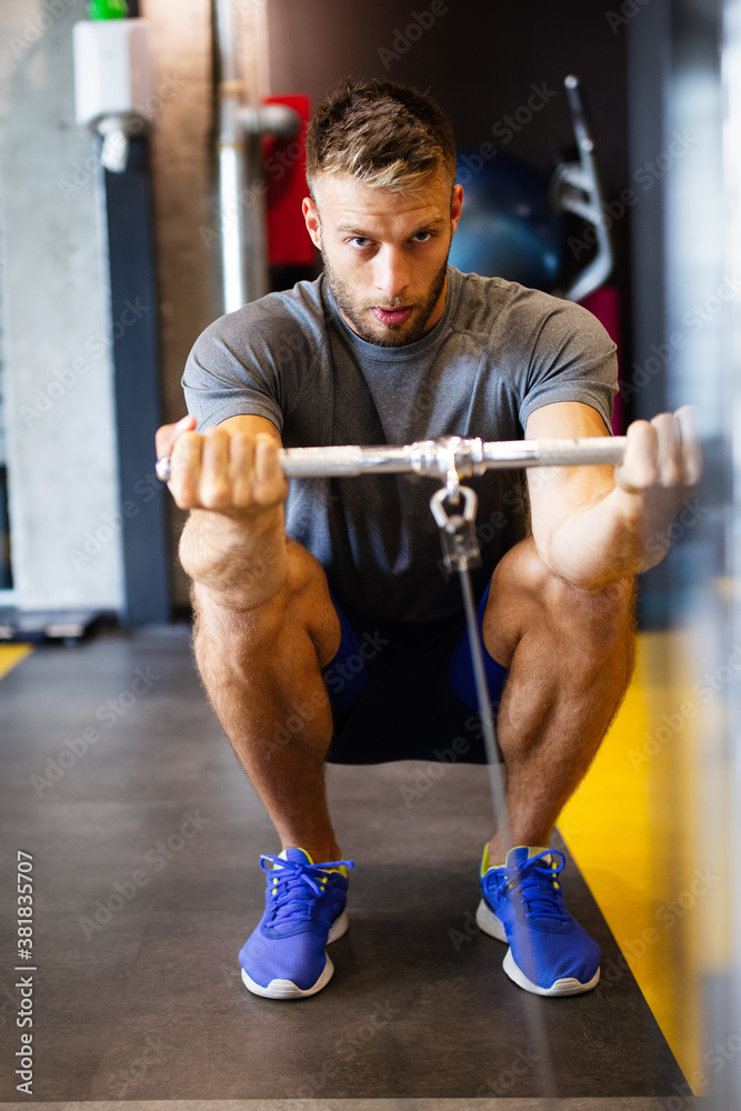 Young handsome man doing exercises in gym Young handsome man doing exercises in gym