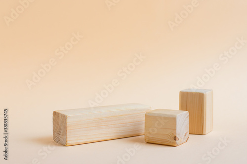 Fototapeta Naklejka Na Ścianę i Meble -  Rectangular wooden shapes on a neutral background with place for text. Empty podium or stand for displaying products, eco cosmetics. Showcase or podium of geometric shapes