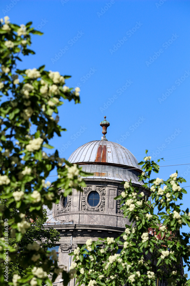 Artistic building in a city among green trees Artistic building in a city among green trees