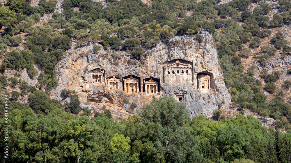 Famous tombs carved inside rocks in ancient Kaunos city, Turkey. Lycian Royal mountain tombs carved into the rocks near the town of Dalyan in the province of Marmaris in Turkey
