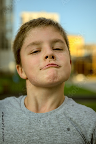 Portrait of a child who squints slyly © dojo666