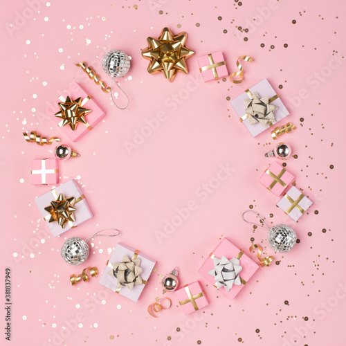 Gold and silver decorations, mirror disco balls, gifts on pastel pink paper background. © Iuliia Metkalova