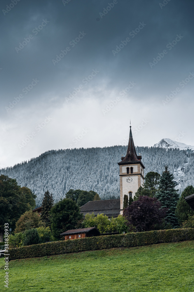 church of Grindelwald in autumn with first snow on the mountains church of Grindelwald in autumn with first snow on the mountains
