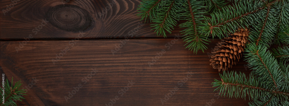 Christmas tree, cones on a wooden brown background.Copy space for your text. Flat lay. New year christmas background. Banner Christmas tree, cones on a wooden brown background.Copy space for your text. Flat lay. New year christmas background. Banner