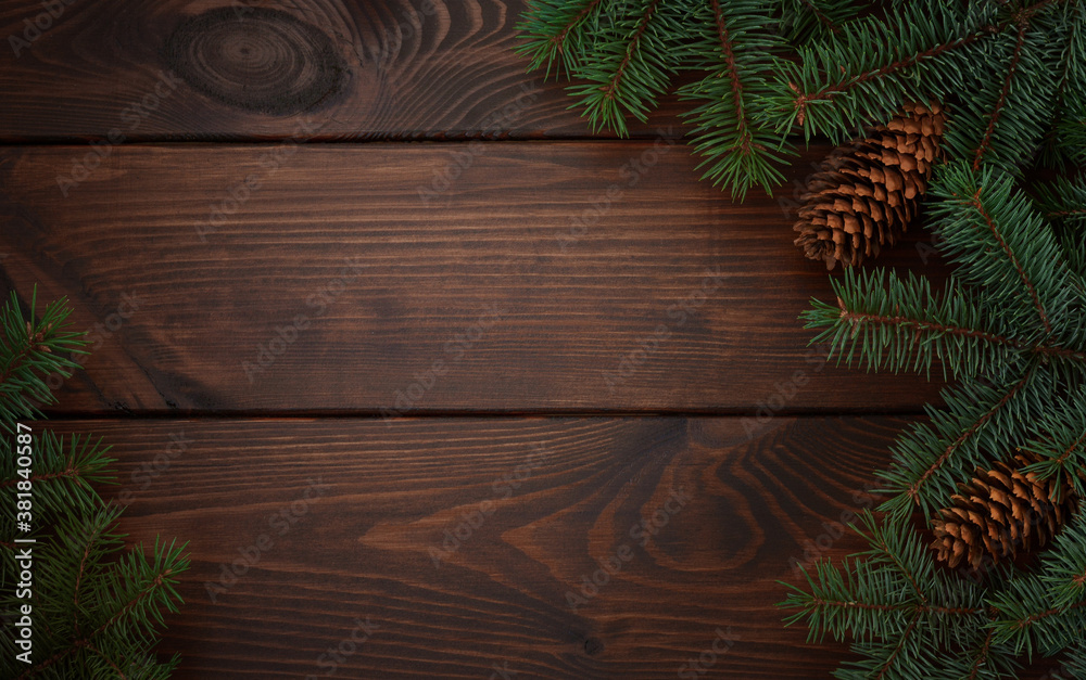 Christmas tree, cones on a wooden brown background.Copy space for your text. Flat lay. New year christmas background Christmas tree, cones on a wooden brown background.Copy space for your text. Flat lay. New year christmas background
